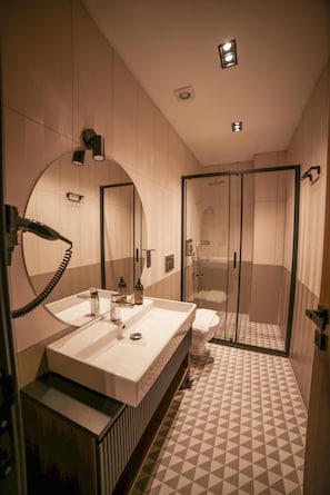 Separate tub and shower, hair dryer, slippers, towels
