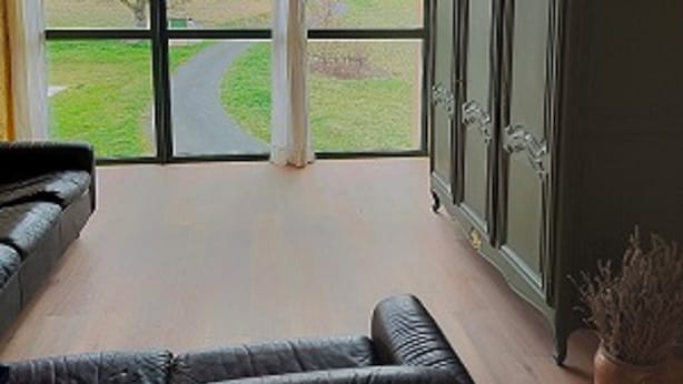 A room with a large window, a black leather sofa, and a green cabinet. - . Special PMR. Near one of France's most beautiful villages. Views (Brousse)