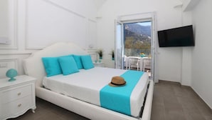 A bedroom with a bed, a nightstand, a TV, and a balcony with a view. - VILLA DEI SRLS in Positano (Positano)