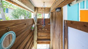 A narrow wooden staircase with a handrail, a light fixture, and a view of the outside. - Walk to Duck Soundfront w Pool, Firepit, Cornhole (Kitty Hawk)