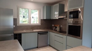 A modern kitchen with a dishwasher, a built-in oven, and a microwave. - An enchanting haven of calm (Andernos-les-Bains)