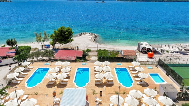 A resort with multiple swimming pools, beach access, and a view of the sea.