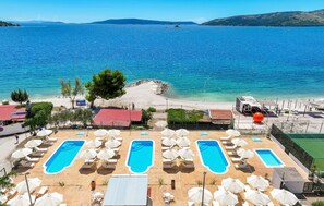 A resort with multiple swimming pools, beach access, and a view of the sea. - Stunning apartment in Seget Donji with WiFi (Seget Donji)