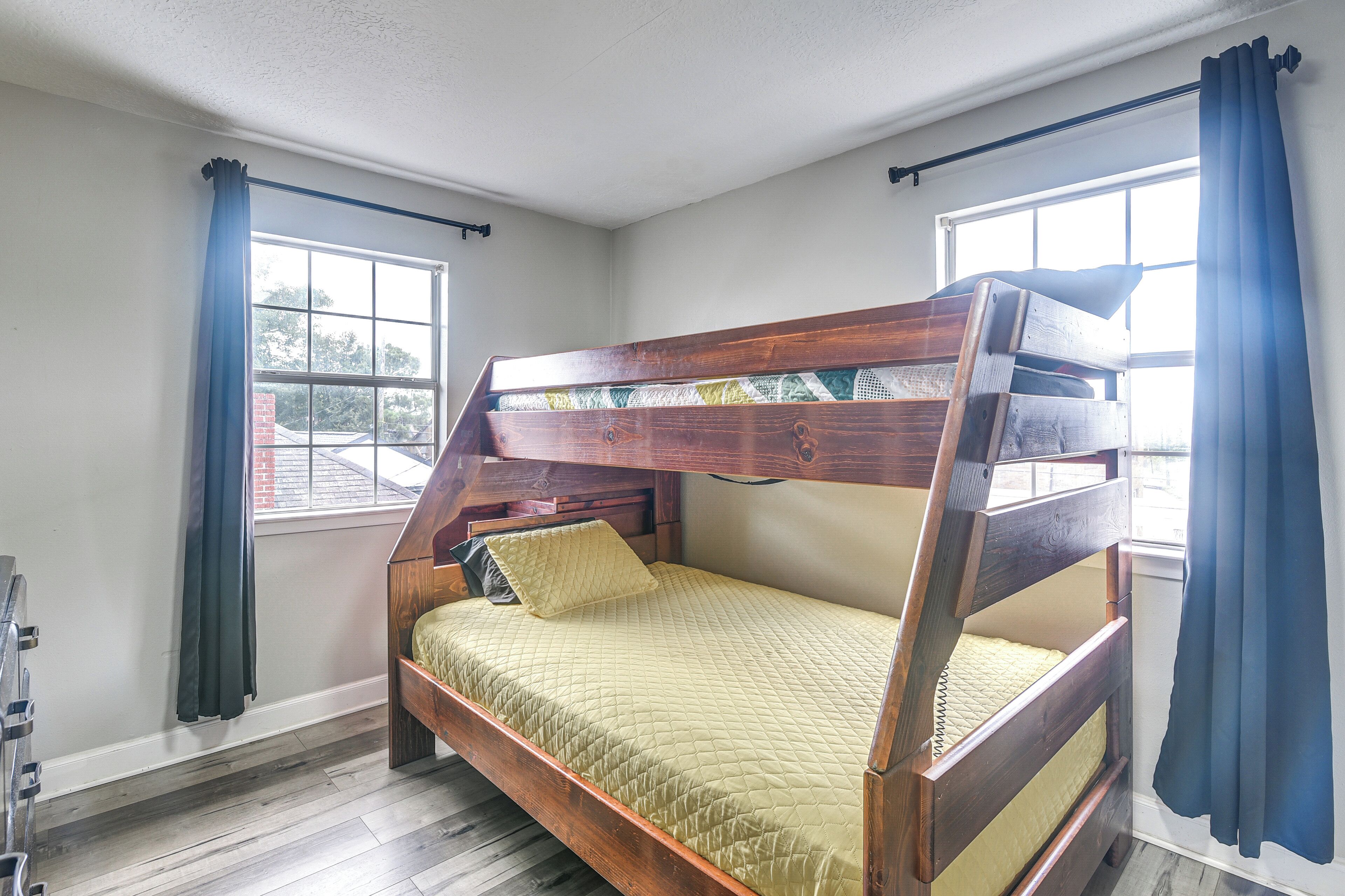 A bunk bed with a wooden frame and a quilted mattress.