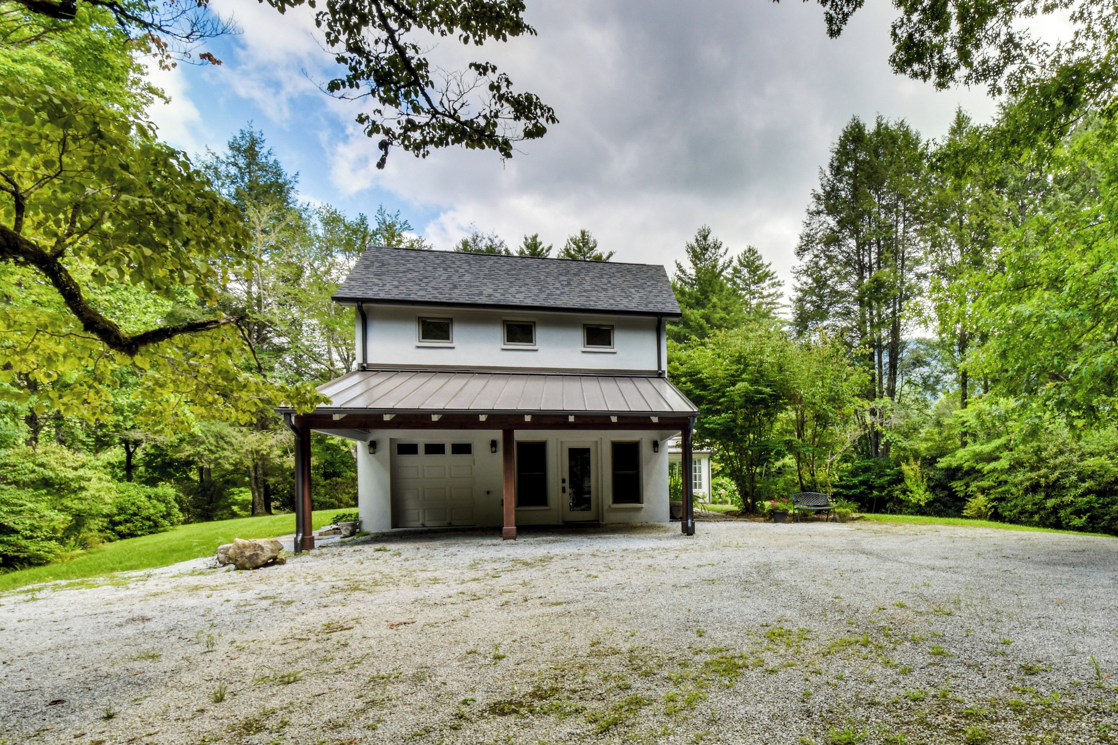 A two-story house with a covered porch and a garage.