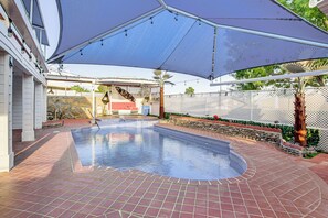 A swimming pool with a covered area, stone walls, and a fence. - 13 Mi to Downtown El Paso: Home w/ Game Room & Bar (El Paso)