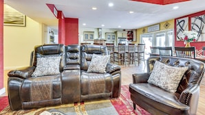 A living room with a sectional sofa, a smaller sofa, and a coffee table. There is a kitchen in the background. - 13 Mi to Downtown El Paso: Home w/ Game Room & Bar (El Paso)
