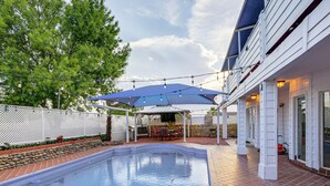 A swimming pool with a patio area, outdoor seating, and a covered section. - 13 Mi to Downtown El Paso: Home w/ Game Room & Bar (El Paso)
