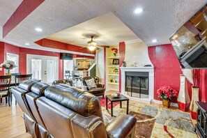 A living room with leather sofas, a fireplace, and a dining area with a table and chairs. - 13 Mi to Downtown El Paso: Home w/ Game Room & Bar (El Paso)
