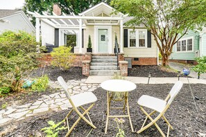 A house with a front porch, two folding chairs, and a small table. - Cookout Ready: Walkable Home in Bearden Village (Knoxville)