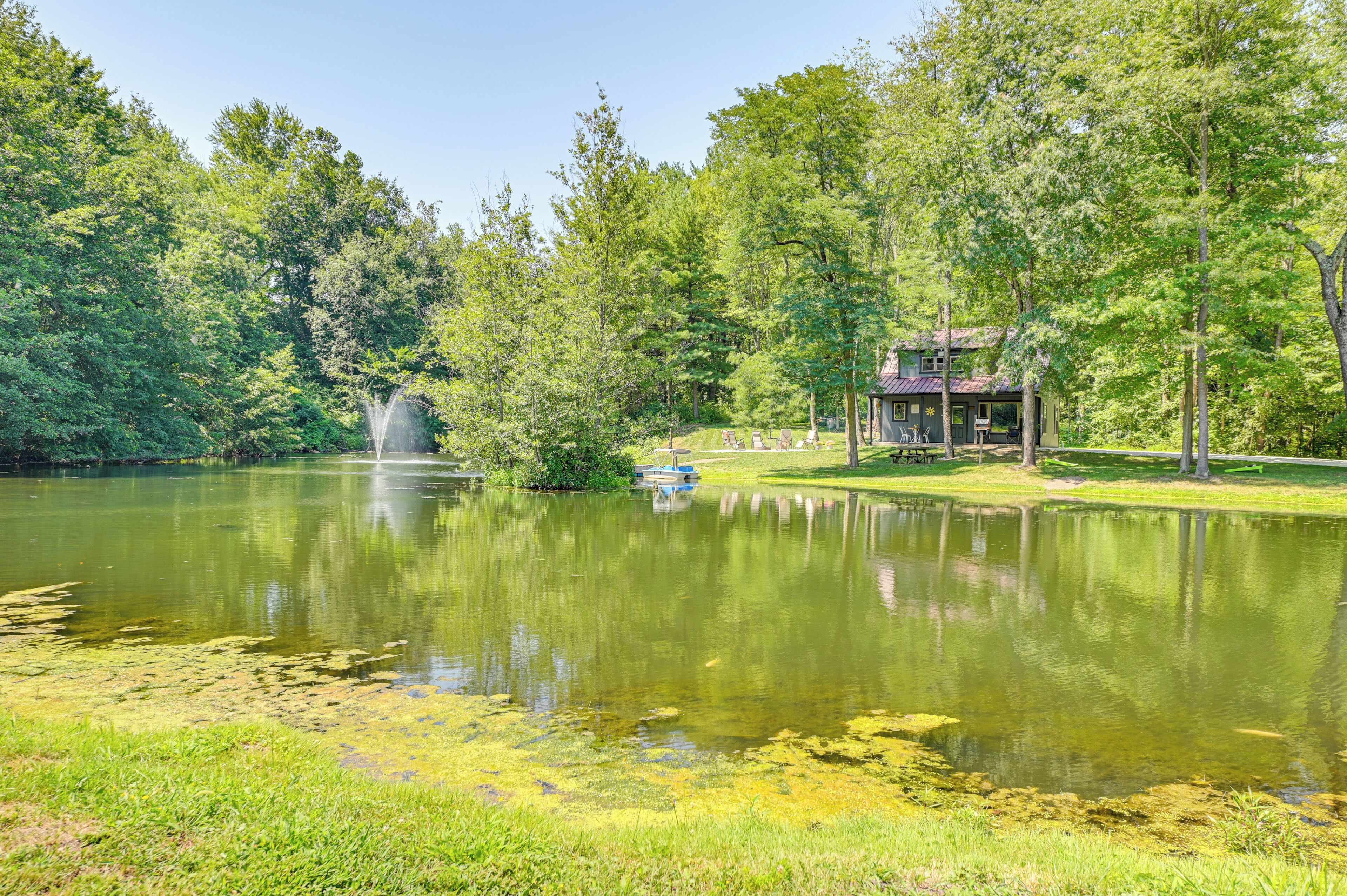 A tranquil lakeside setting with a gazebo and a small dock.