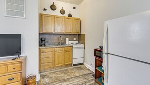 A kitchen with wooden cabinets, a white refrigerator, a stove, and a sink. - 2 Mi to Main Street! Cozy Winfield Launchpad (Winfield)