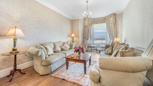 A living room with a sofa, armchair, coffee table, and lamps. - Pier View House - Blackpool (Blackpool)