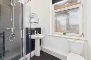Shower, hair dryer, towels, shampoo