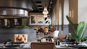 A restaurant with a central bar, seating arrangements, and decorative elements like plants and artwork. - Jadran Heritage Hotel Valamar Collection (Poreč)
