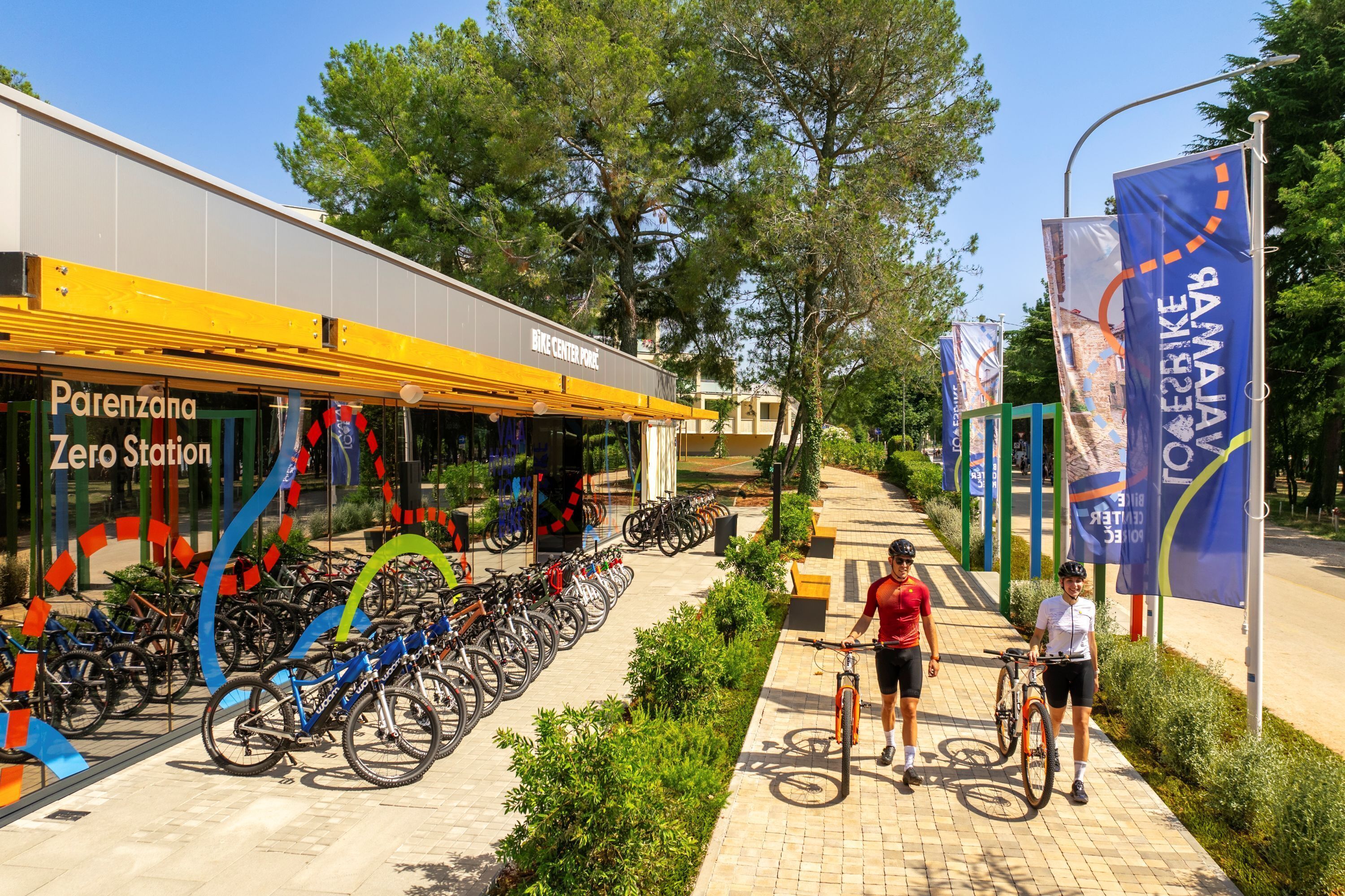 A bike parking area with a building labeled 'Parenzana Zero Station' and a row of bicycles.