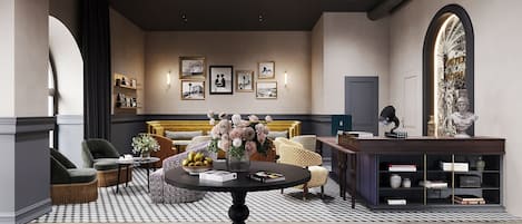 Un salon bien éclairé, avec une table ronde, des canapés et une bibliothèque.