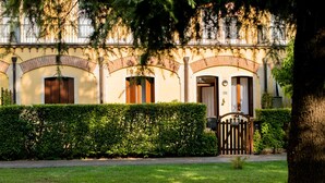 A building with a brick facade, arched windows, and a gated entrance.
