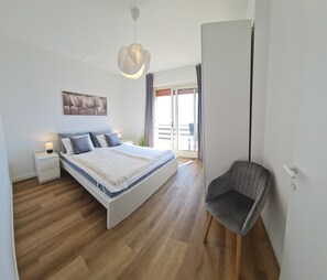 A bedroom with a bed, bedside table, lamp, and a chair. - House Lili Le Balze Lake view (Tremosine)