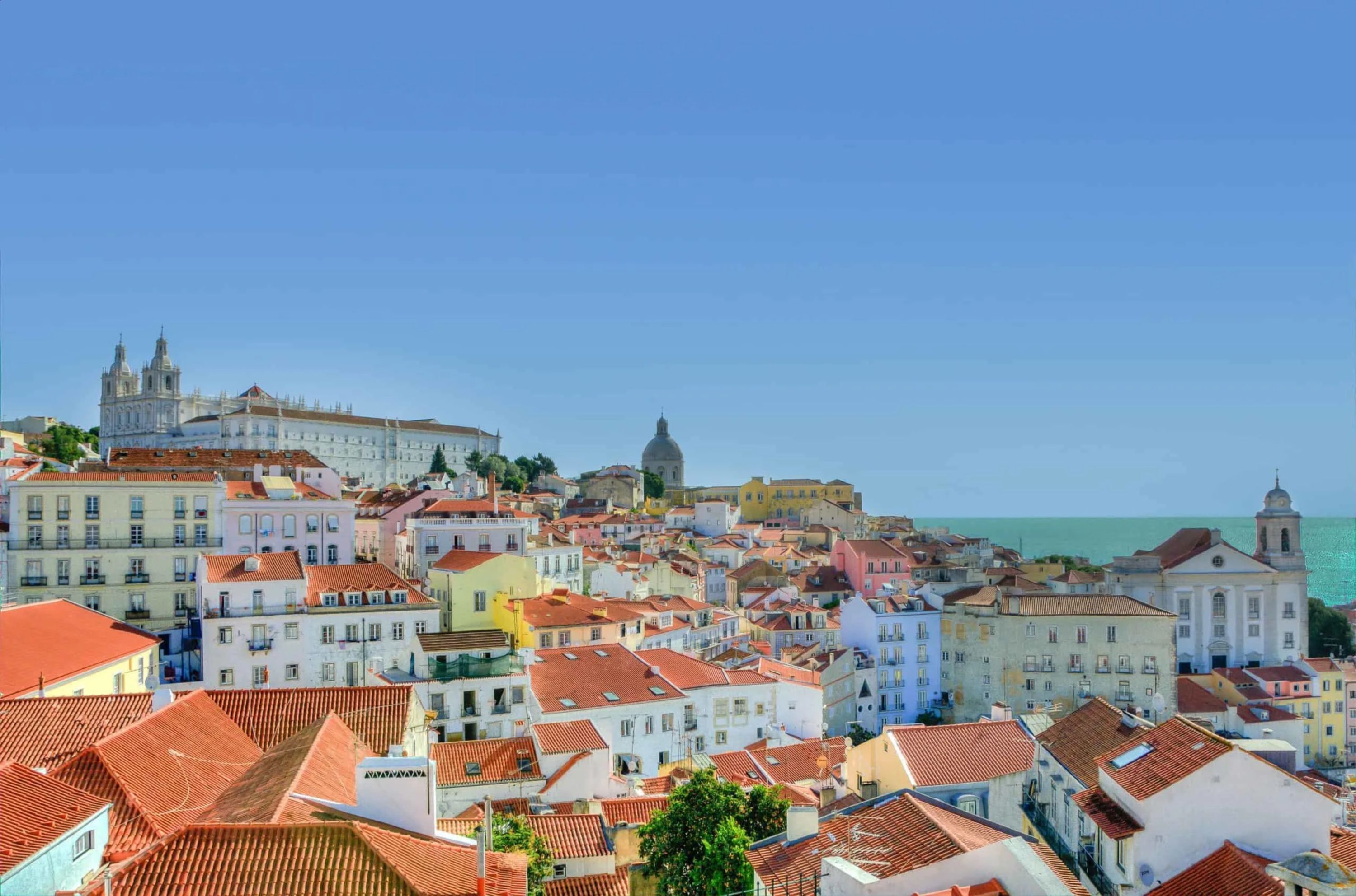 A coastal cityscape with historic buildings and a prominent cathedral.