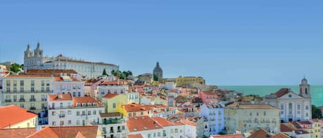 A coastal cityscape with historic buildings and a prominent cathedral.