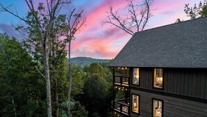 A multi-story building with a balcony, surrounded by trees and a scenic view of hills. - Perfect Family Retreat MTN Views Pool Privacy (Sevierville)