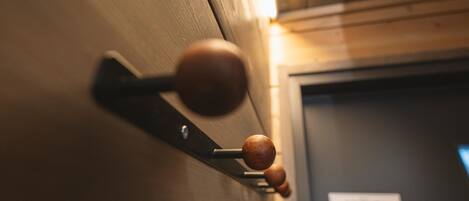 A close-up of a wooden door handle with a metal latch.
