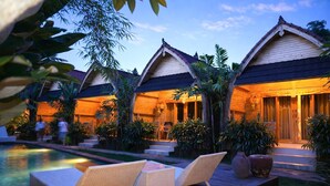 A resort with multiple bungalow-style accommodations, a swimming pool, and lush tropical landscaping. - Penida Green Palm Cottage (Penida Island)