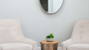 Two armchairs facing each other with a small table between them.