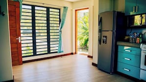 A kitchen with a refrigerator, a microwave, and a sink. - The View Studio - by Zenbreak (Gros Islet)