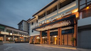 A hotel entrance with a sign reading "Magnotel Classic" and a covered outdoor area with seating. - Magnotel Guilin Elephant Trunk Hill (Guilin)