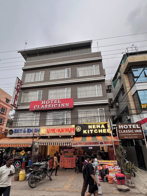 A multi-story building with a prominent 'HOTEL CLASSIC INN' sign.