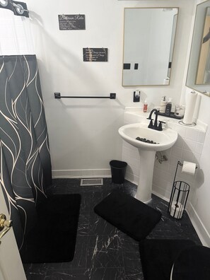 Jetted bath, hair dryer, towels, toilet paper