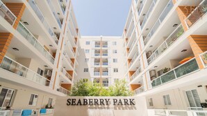 A multi-story residential building with balconies, a central garden area, and a sign reading "SEABERRY PARK". - Lovely, fully equipped 2BR home 5 min from beach (St. Paul`s Bay)
