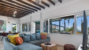 A modern living room with a sectional sofa, wooden coffee table, and a television. - Holiday Villa 'Dafmir' with Sea Views, Wi-Fi and Air Conditioning (Tías)