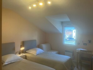 Family Triple Room, City View | Desk, laptop workspace, blackout drapes, iron/ironing board