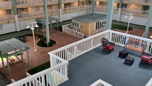 A multi-level atrium with outdoor seating areas, railings, and a central garden. -  Updated Oceanfront 2 br. getaway balcony view, steps to pool, walk to beach! (Hilton Head Island)