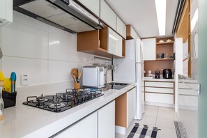 Fridge, microwave, coffee/tea maker, cookware/dishes/utensils