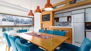 A modern kitchen with wooden cabinets, a built-in oven, and a refrigerator.