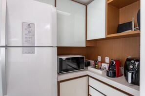 Fridge, microwave, coffee/tea maker, cookware/dishes/utensils