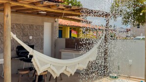 A pool area with a hot tub, a hammock, and a poolside chair. - Comfort, location, and unforgettable landscapes in Maragogi! (Maragogi)