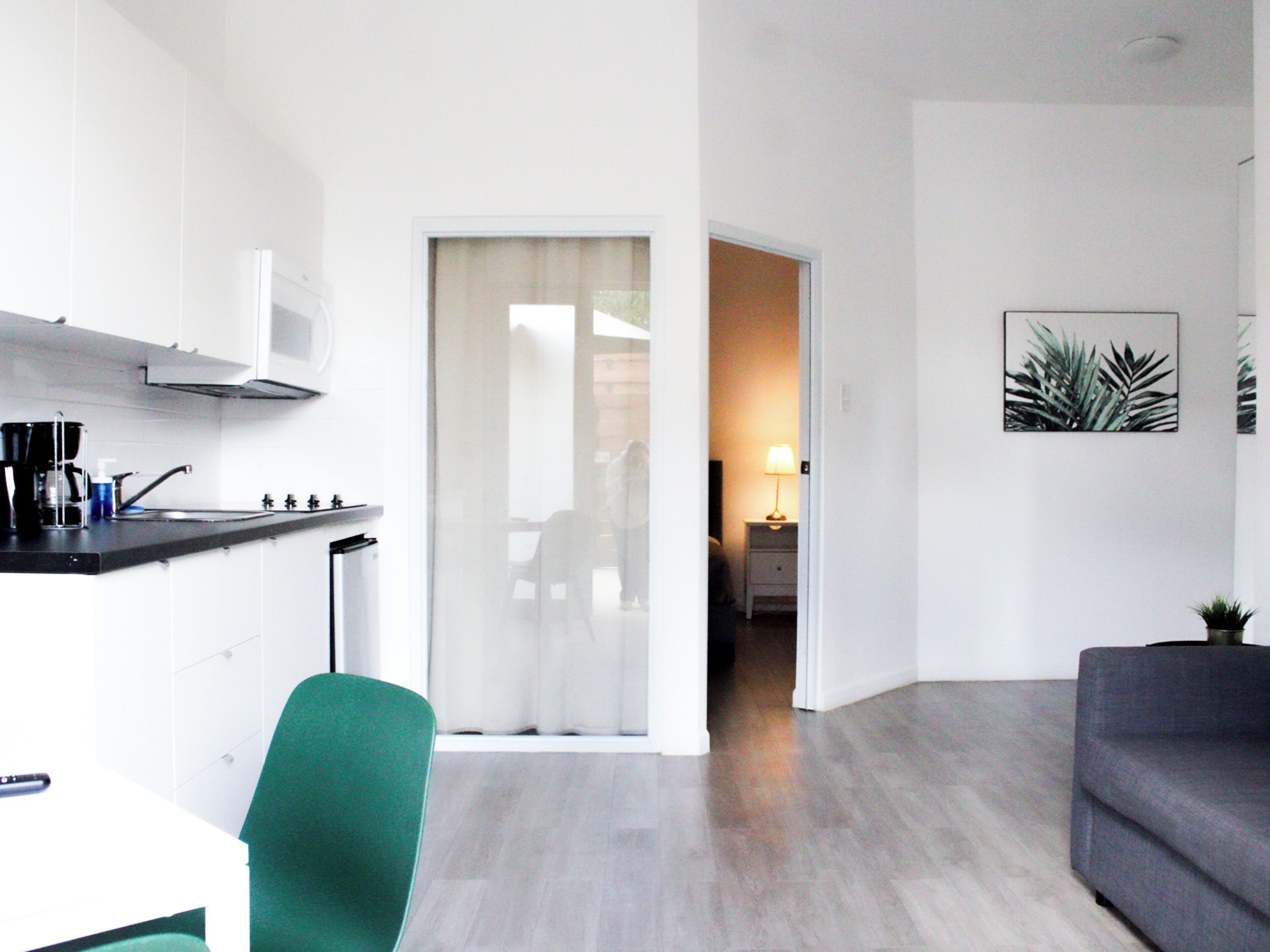 A modern apartment with a kitchen, a dining area, and a living room.