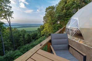 A wooden deck with a view of a forest and a transparent dome structure. - The Dome At The Ridge-A Glamping Experience On The Bourbon Trail (Raywick)