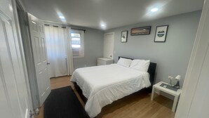 A bedroom with a bed, bedside table, and a window. - Spacious 3-Bedroom Home Awaits 2nd Floor - Designed for Comfort & Relaxation!!! (New Britain)