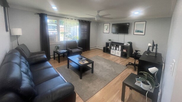 A living room with a sofa, coffee table, TV, and a desk with a computer. - Spacious 3-Bedroom Home Awaits 2nd Floor - Designed for Comfort & Relaxation!!! (New Britain)