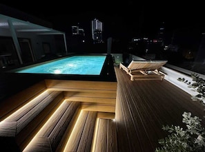 A rooftop pool area with wooden flooring and seating. - Sky villa penthouse, private pool | MIL by Homega (St. Julian's)