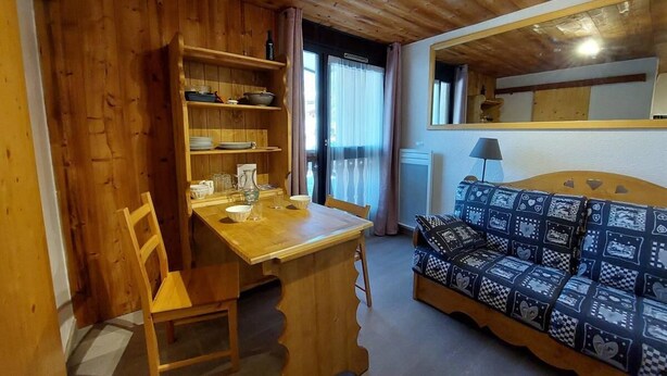 A wooden interior with a dining table, chairs, a sofa, and a shelf with kitchen items. - 50m from ski slopes, Ground floor, view parking, parking, tv, ski locker, 12m², Les 2 Alpes (Les Deux Alpes)