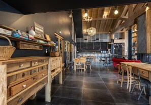 A modern interior with wooden furniture, a dining area, and a cozy seating area.