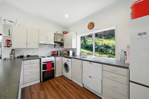 Fridge, microwave, dishwasher, toaster - Maison Pierre Rouge - Duvauchelle Holiday Home (Banks Peninsula)