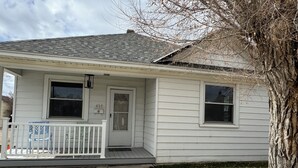 A single-story house with a front porch, a mailbox, and a number '417' on the door.